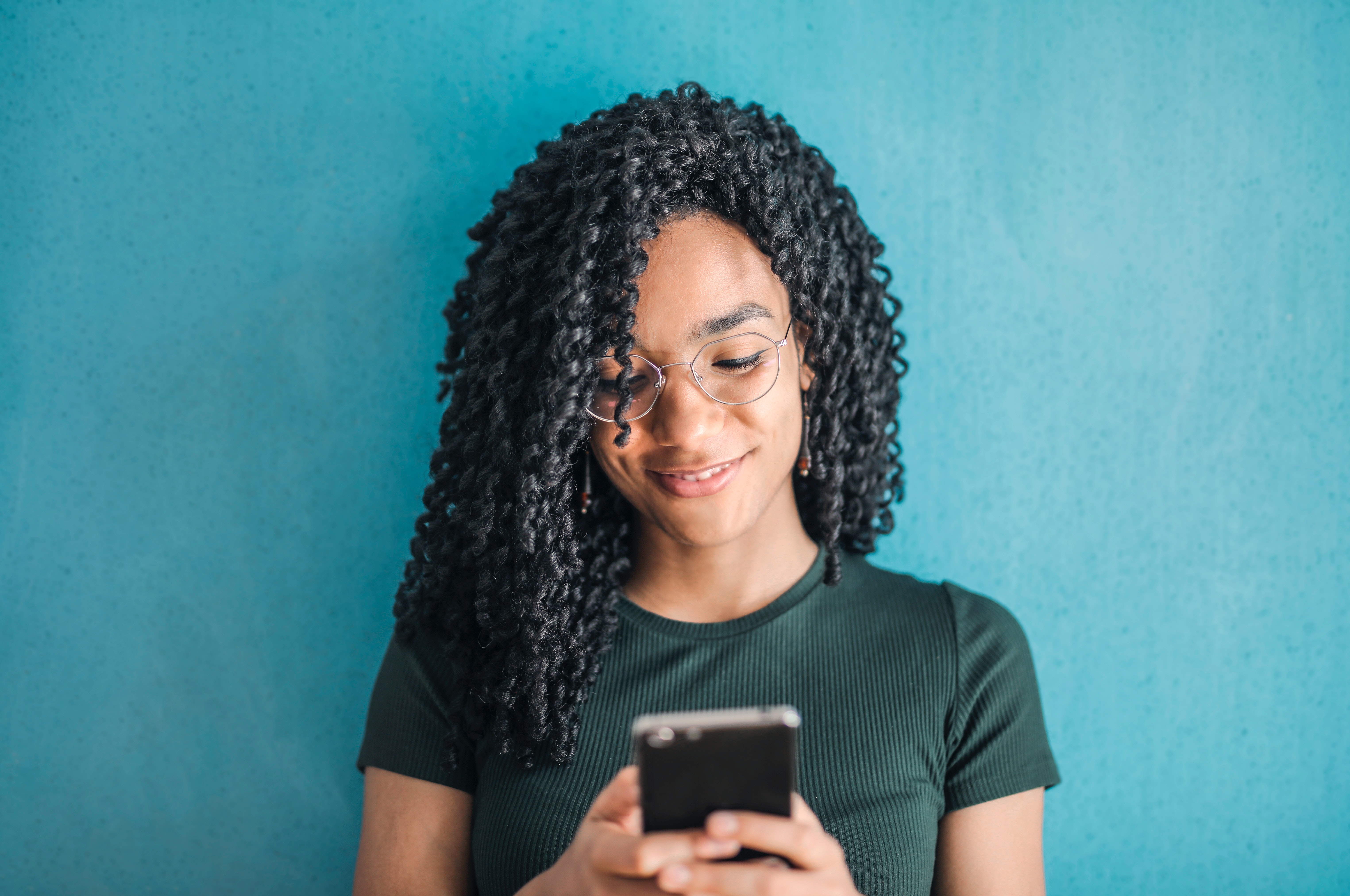 portrait-photo-of-smiling-woman-in-black-t-shirt-and-glasses-3769022